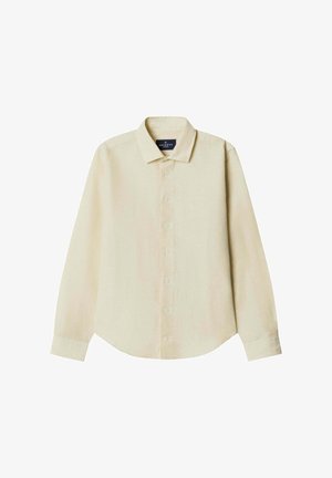 Chemise à manches longues beige clair avec col classique, boutonnage frontal et ourlet arrondi. Texture lisse et marquage subtil sur la poitrine.