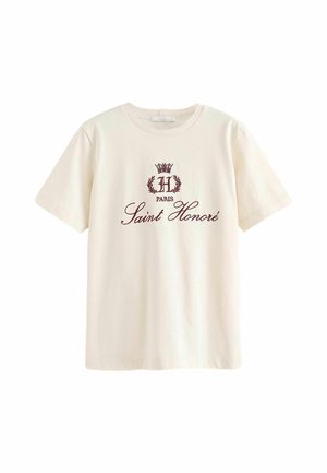 T-shirt crème à manches courtes en coton, avec un logo bordeaux représentant une couronne, la lettre "H" et le texte "Saint Honoré", situé au centre à l'avant.