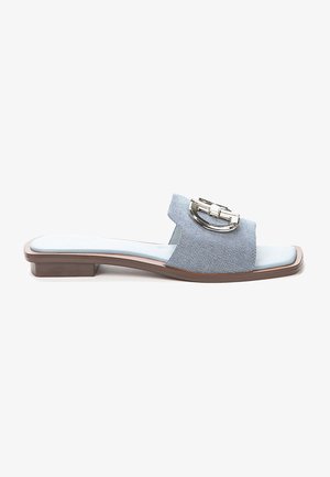 Light blue slide sandal made of fabric with a textured design, featuring a silver buckle accent and a low, square heel. Flat sole.