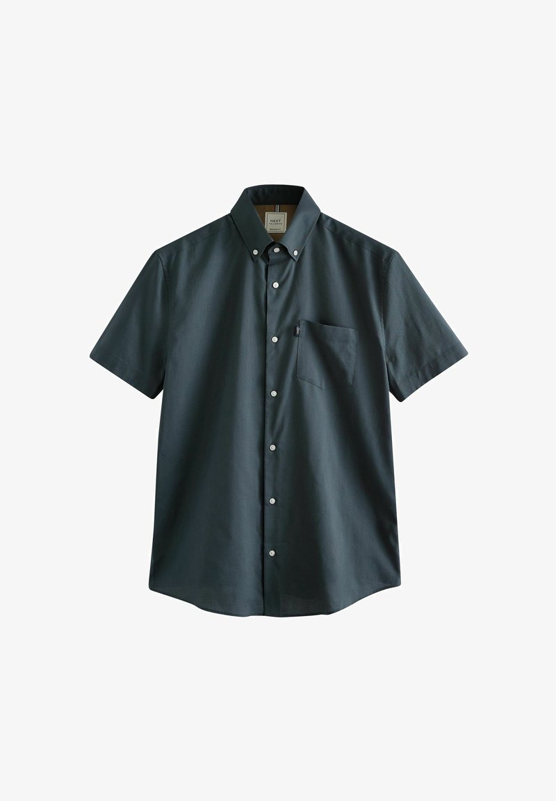 Rövid ujjú gombos ing sötétzöld színben, pamut keverékből készült. Mellzsebbe van varrva, fehér gombokkal, klasszikus gallér kialakítással.