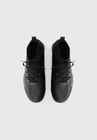 Black athletic shoes with a textured design, featuring contrasting blue accents, round toe, and black laces. Smooth, flexible material.