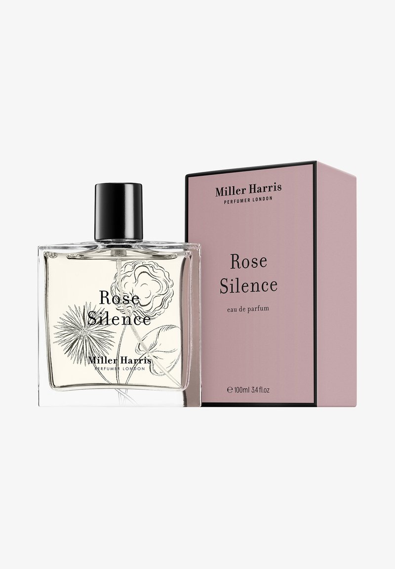 Rose Silence eau de parfum in a clear glass bottle with a black cap, featuring floral line art. Accompanied by a pink box with black accents.
