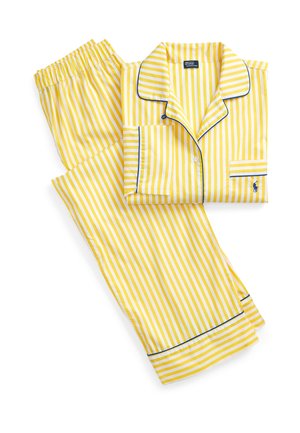 Gelb-weiß gestreifter langärmeliger Pyjama mit blauen Paspelierungen, Hemd mit Knopfleiste, Hosen mit elastischem Bund und kleinem besticktem Logo.