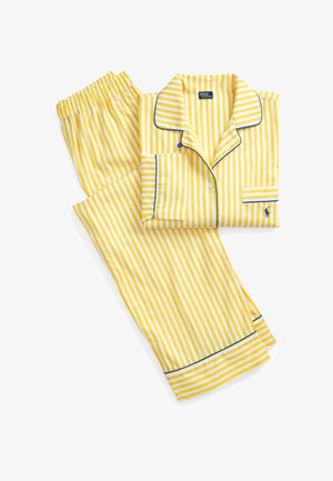 Gelb-weiß gestreifter langärmeliger Pyjama mit blauen Paspelierungen, Hemd mit Knopfleiste, Hosen mit elastischem Bund und kleinem besticktem Logo.