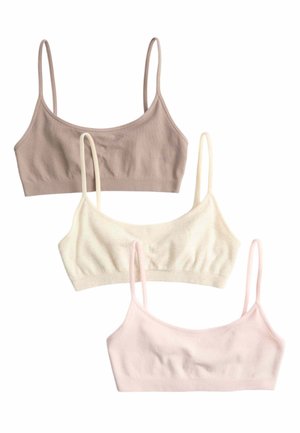 Trzy bezszwowe bawełniane topy bralette w kolorach beżowym, ecru i pastelowym różowym z cienkimi ramiączkami, ułożone pionowo na białym tle.