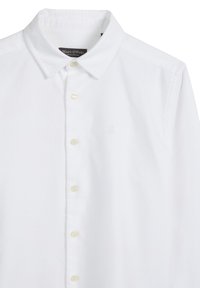 Witte blouse van katoen. Voorzien van een klassieke kraag, parelknopen en een subtiel geborduurd logo. Gladde textuur met een nette afwerking.