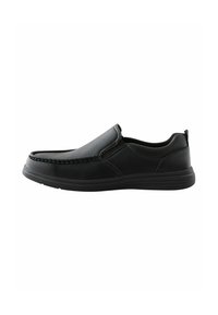 Black slip-on shoe with a smooth leather upper, textured stitching along the toe, and a flexible rubber sole. Minimalist design.
