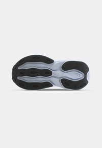 Shoe sole with a patterned design; predominantly black with white accents. Features a smooth texture and various shaped cutouts for flexibility.