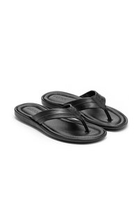 Musta flip-flop sandaalit, jotka on valmistettu sileästä nahasta. Varustettu varvaslenkillä, pehmeällä pohjalla ja teksturoidulla pohjalla pitävyyden takaamiseksi.