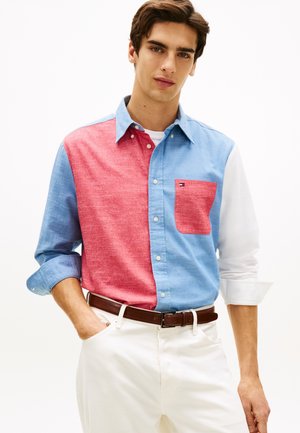 Košeľa s farebnými blokmi v červenej a svetlomodrej farbe, s jedným náprsným vreckom a golierom na gombíky; bavlnená tkanina, dlhé rukávy.