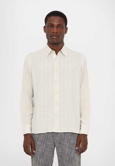 Light beige long-sleeve shirt with vertical stripes in blue and grey, button-up design, and a standard collar; smooth fabric texture.