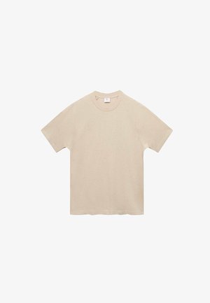 Beige Baumwoll-T-Shirt mit rundem Halsausschnitt und kurzen Ärmeln, das eine lockere Passform und eine glatte, weiche Textur aufweist.