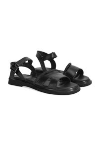Schwarze Leder-Sandalen mit offener Zehenpartie, Kreuzriemen-Design und verstellbarem Schnallenverschluss. Strukturierte Innensohle und flache Gummisohle für Komfort.