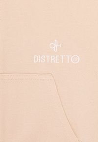 Felpa beige con cappuccio caratterizzata da una tasca a canguro e logo ricamato bianco "DISTRETTO" con un accento circolare. Tessuto morbido e strutturato.