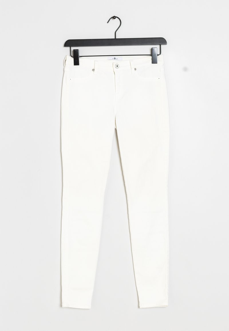 White slim-fit jeans with front button, belt loops, and five pockets hanging on a black plastic hanger against a white background.