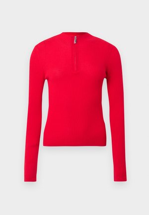 Crveni rebrasti top s dugim rukavima, uskog kroja, s visokim izrezom i kratkim patentnim zatvaračem sprijeda. Mekana tekstura i elegantan dizajn.