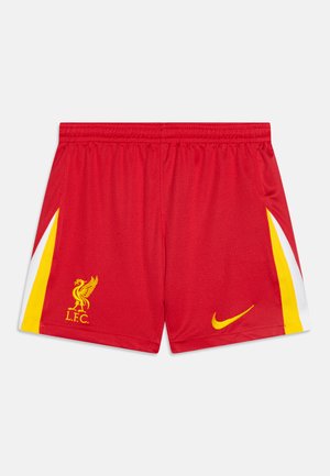 Sarkani futbola īsie šorti, kas izgatavoti no elpojoša auduma, ar baltām un dzeltenām akcentiem, ar Liverpūles FC logo un Nike zīmolu.