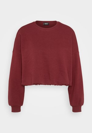 Crop top sweatshirt in dark red, made of soft cotton. Features long sleeves and a ruffled hem. Simple crew neck design.