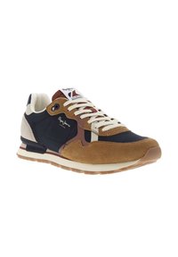 Men's sneakers featuring navy blue synthetic upper with brown suede accents, cream laces, and a textured rubber sole. Brand logo present on tongue.