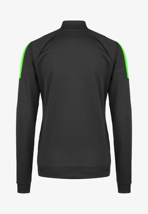 Zwarte sportjack met lange mouwen, hoge kraag en groene accenten op de schouders. Gladde textuur met elastische manchetten en zoom.