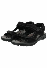 Schwarze Sandalen mit verstellbaren Klettverschlüssen, einer gepolsterten grauen Innensohle, einer strukturierten Gummisohle und kontrastierenden weißen Nähdetails.