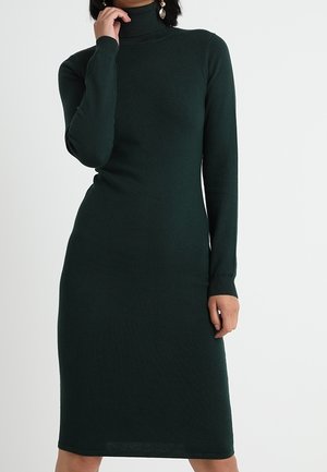 Abito a collo alto lavorato a maglia di un verde scuro, con maniche lunghe, silhouette aderente e orlo fino al ginocchio. Tessuto liscio, polsini a coste.