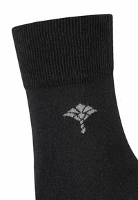 Schwarze Socke mit geripptem Bund und einem Blattmuster in Hellgrau am Knöchel. Glatte Textur, mittellange bis zur Wade.