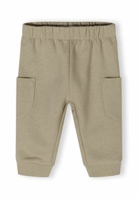 Bézs színű tréningnadrág elasztikus derékpánttal, bordázott szegélyekkel és két oldalzsebbel. Puha, sima tapintású anyagból készült.