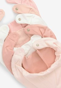 Set of fabric bibs in shades of pink and white, featuring snaps, soft texture, and a rounded design.