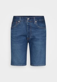 Calções de ganga em azul escuro com um corte reto, design de cinco bolsos, acabamentos em cobre e bainha crua.