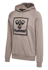 Beige huvtröja med en stor svart "hummel" logotyp och grafisk design på framsidan. Har en känguruficka och ribbade muddar.