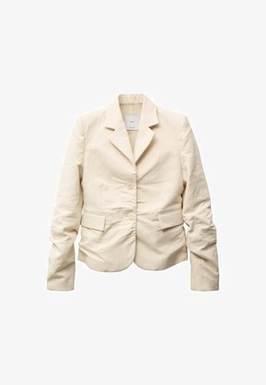 Jachetă bej, croit special, cu guler cu colțuri, două buzunare frontale și închidere cu buton frontal. Material neted cu o ușoară textură și croi structurat.