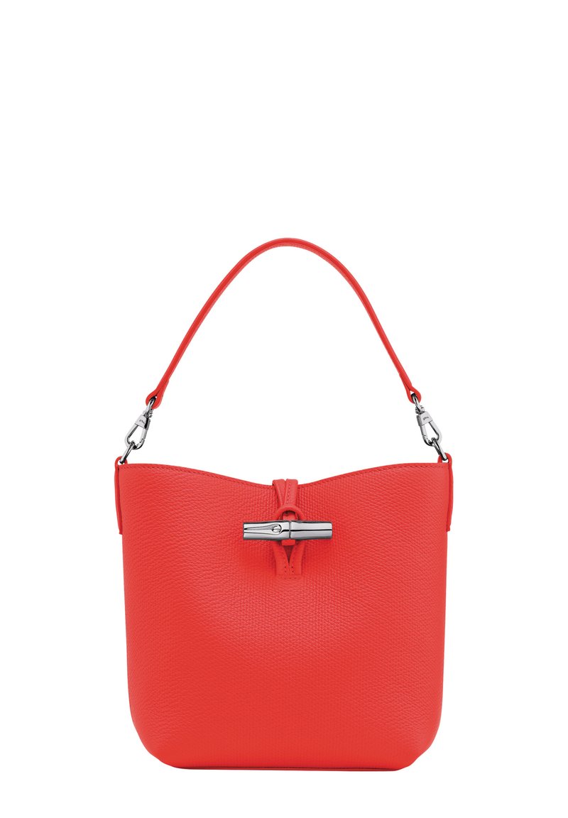 Red textured leather handbag with a single rounded handle and a prominent metallic clasp at the front. Smooth finish, minimalist design.