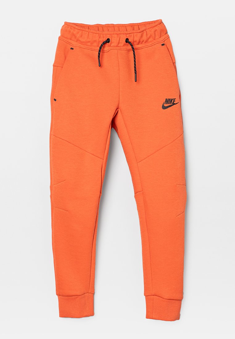 Helle orangefarbene Nike-Sweatpants mit elastischem Bund, schwarzem Kordelzug und Logo. Verfügt über Teilungsnähte und zwei Vorderentaschen.