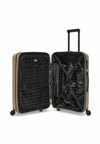 Valise rigide beige avec quatre roues, poignée télescopique, ouverte pour montrer un intérieur noir avec des poches d'organisation et des sangles croisées.