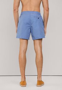 Pantaloni da bagno blu a fantasia realizzati in tessuto leggero, con una piccola tasca posteriore e un dettaglio con bottone a contrasto.
