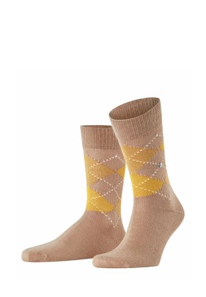 Calze beige con motivo argyle giallo e marrone chiaro, con una leggera costina in cima e una texture liscia. Accenti bianchi a forma di diamante.