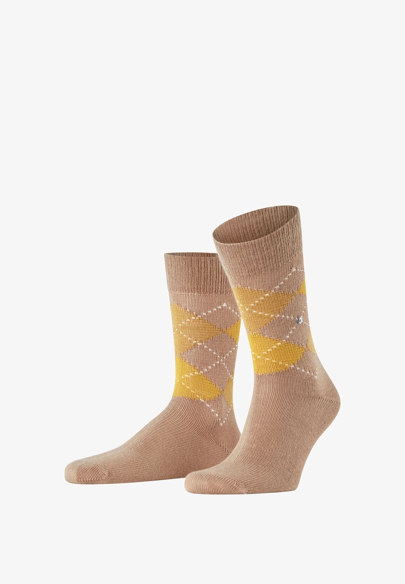 Calze beige con motivo argyle giallo e marrone chiaro, con una leggera costina in cima e una texture liscia. Accenti bianchi a forma di diamante.