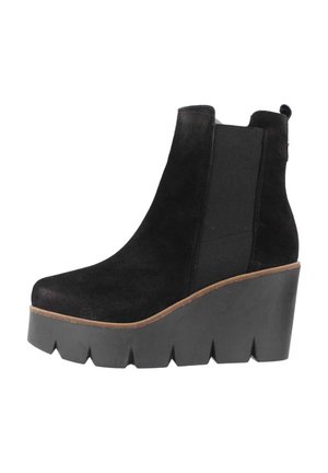Black suede ankle boot with a wedge heel, featuring elastic side panels and a textured sole. The design has a smooth finish and clean lines.