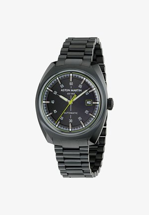 Schwarze Edelstahl-Uhr mit rundem Zifferblatt, leuchtenden Stundenmarkierungen, grauem Zifferblatt, gelben Akzenten und Datumsanzeige bei 3 Uhr.