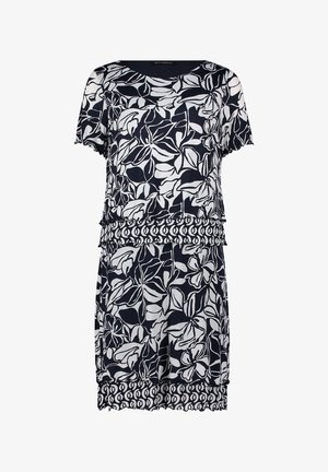 Robe noire et blanche à manches courtes avec motif floral, détails à volants superposés et bandes à motifs géométriques contrastants à la taille et à l’ourlet.