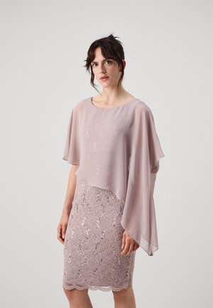 Light pink dress with a flowing chiffon cape and a fitted lace skirt featuring sequins. Textured details and a scalloped hemline.
