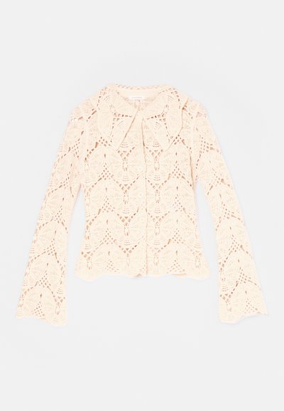 Lace blouse featuring a butterfly pattern, cream color, long flared sleeves, collar, and button-down closure. Textured, lightweight fabric.