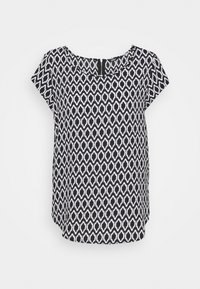 T-shirt med korte ærmer i sort og hvid med et geometrisk mønster over det hele, rund halsudskæring og lynlås i midten på ryggen. Letvægtsstof.