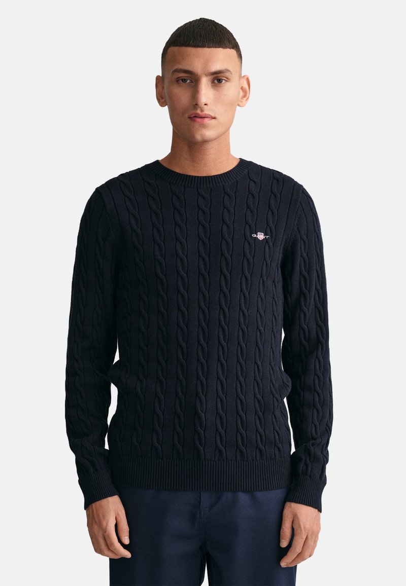 Marine gebreid sweater met kabelontwerp, ronde hals en geribde manchetten en zoom. Geborduurd logo op de borst. Lichtgewicht stof.