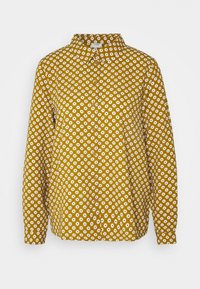 Camicia gialla con bottoni, con motivi floreali bianchi, maniche lunghe e colletto. Realizzata in tessuto leggero, presenta una vestibilità dritta e un orlo dritto.
