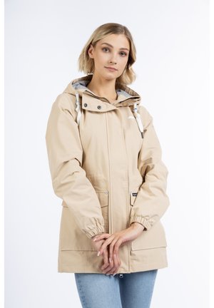 Beige Kapuzenjacke mit elastischen Bündchen und Saum, ausgestattet mit grauem Innenfutter, Kordelzugkapuze und zwei Fronttaschen mit Druckknopfverschluss.