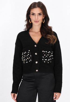 Schwarzer gestrickter Cardigan mit V-Ausschnitt, ausgestattet mit zwei Taschen, die mit runden, perlenähnlichen Akzenten und glänzenden Knöpfen verziert sind.