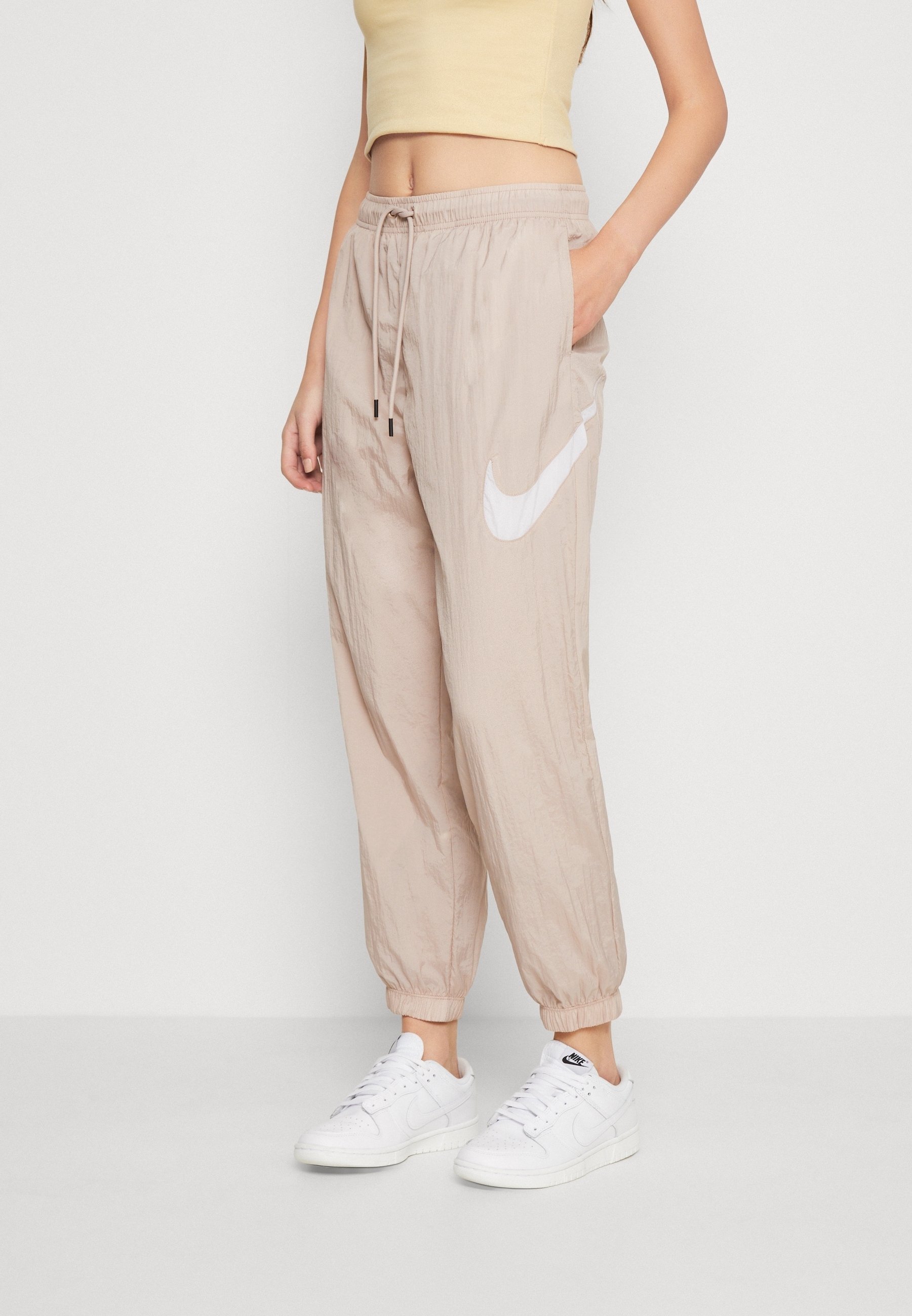 beige nike tracksuit womens