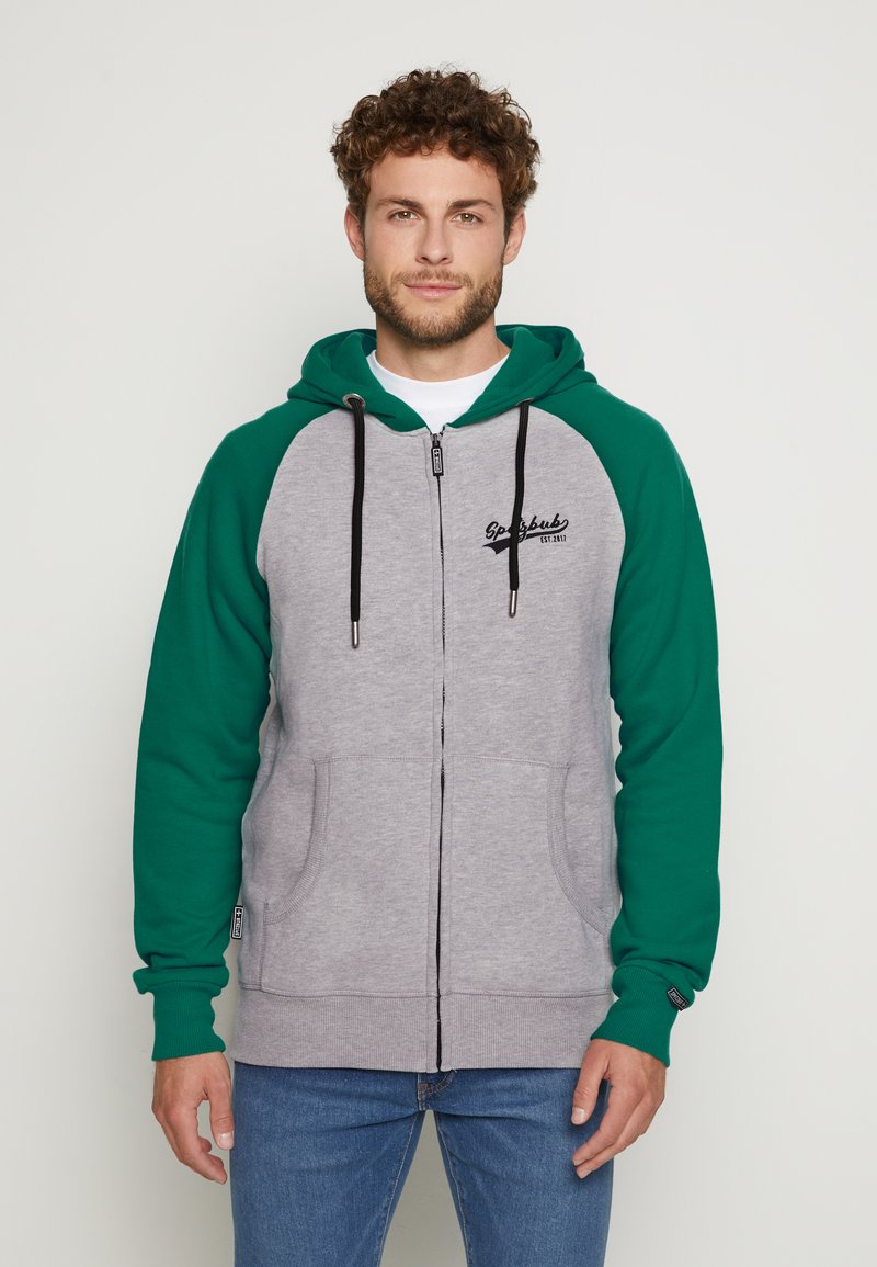 Graue und grüne Zip-Hoodie mit einem zweifarbigen Design, weichem Textil, verstellbarem Zugband für die Kapuze und Fronttaschen. Mit Logo-Detail.